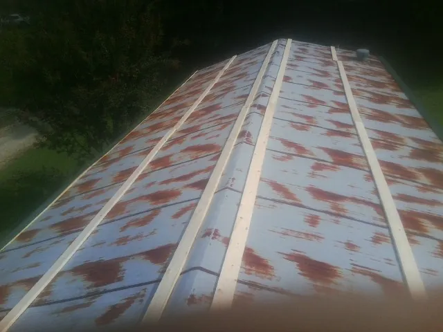 Rusted metal roof panels with new wood purlins before replacement — Storm Damage Roof Repair in Pecatonica by Roofing Brothers